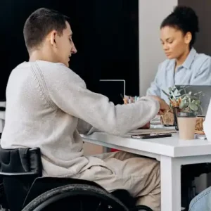 participant in wheelchair doing craft activity